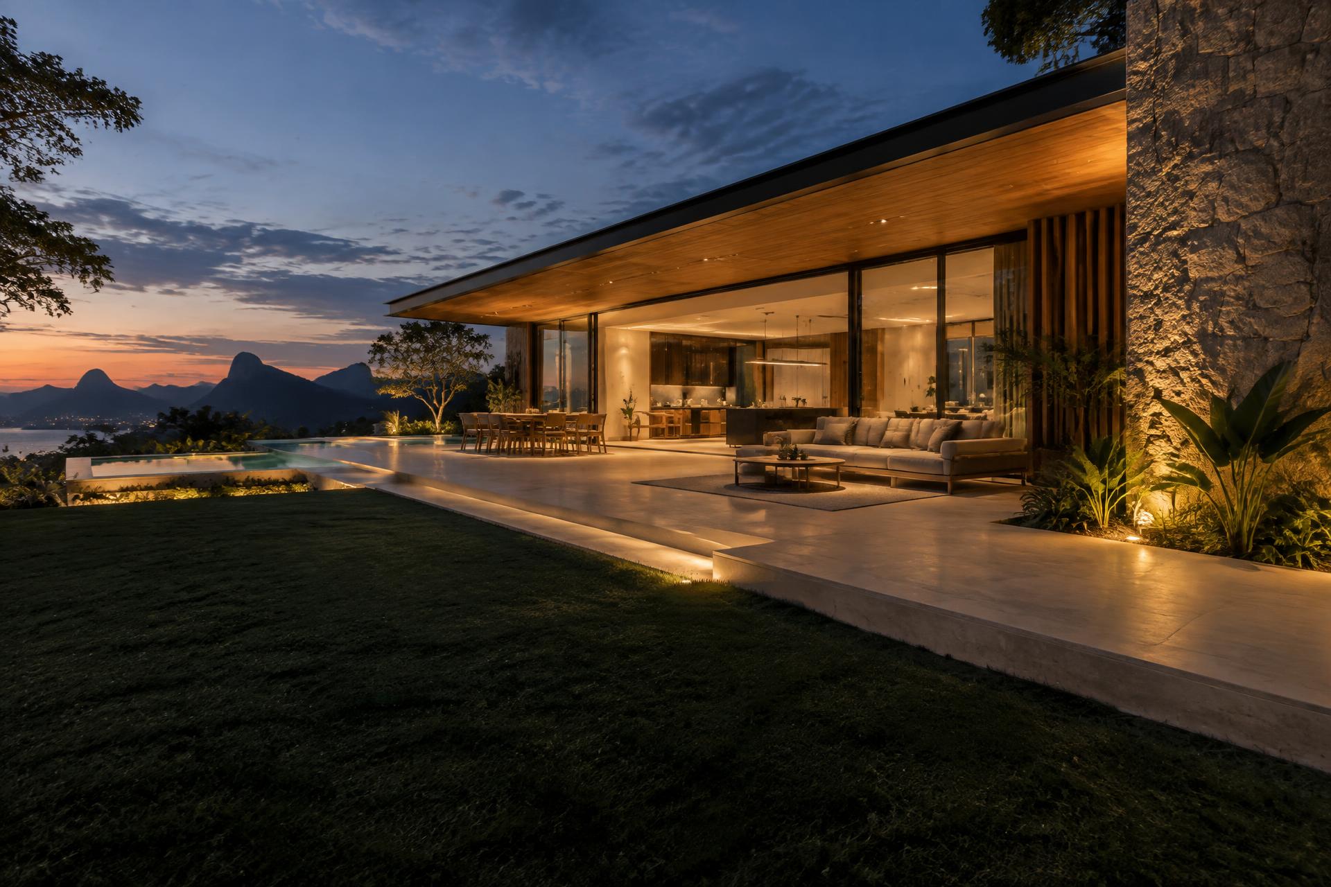 Terraço contemporâneo com pedra natural e iluminação ao entardecer